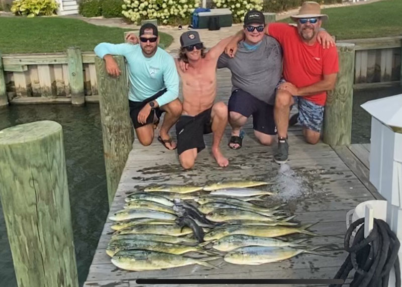 anglers with a catch of mahi